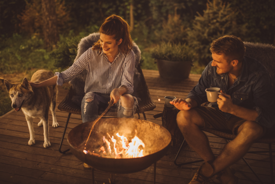 A man and a woman sitting next to a fire in the evening. This represents an image of an ideal relationship where the man and woman enjoy a meaningful relationship and have managed to create the relationship they want.