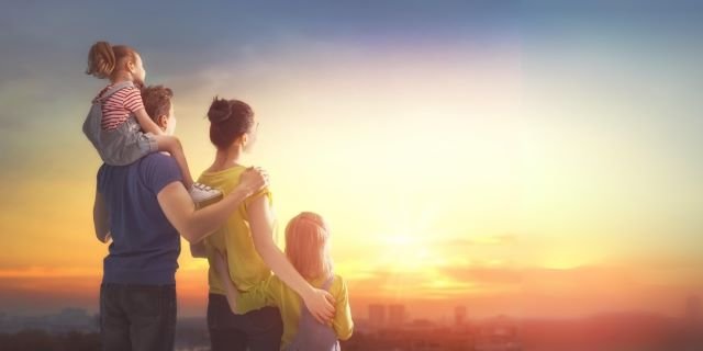 Photo of a happy family watching the sunset after having attended the Relationship Success Programme.